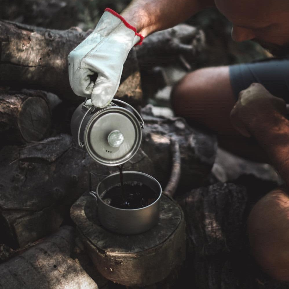 A man is pouring coffee with Bestargot Titanium French Press